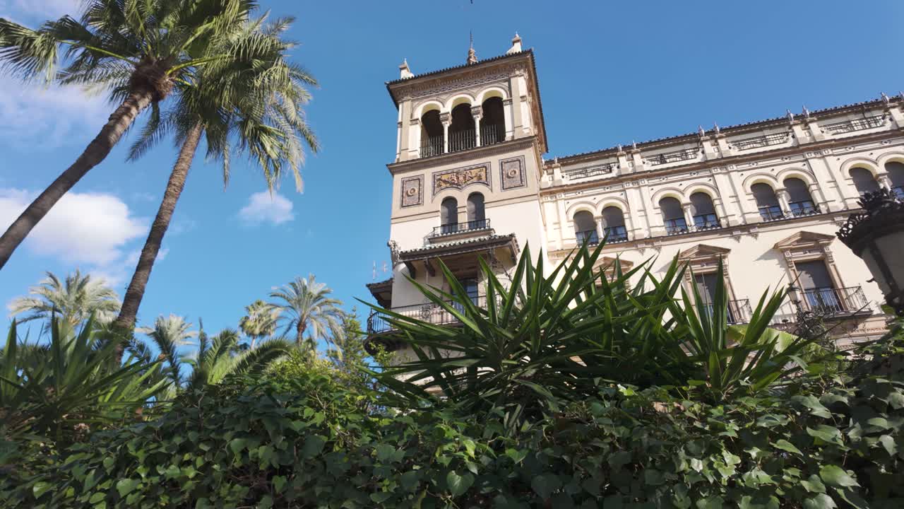 Seville, Spain, view of the lush greenery and iconic architecture of Hotel Alfonso XIII