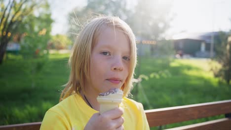 boy eating ice cream in a park