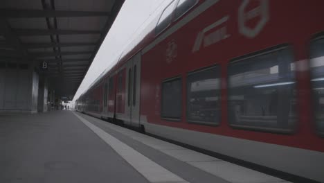 red train at a station platform