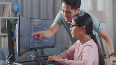 two people working on code together