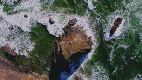 aerial descending above ocean rock, breaking waves patterns, textures