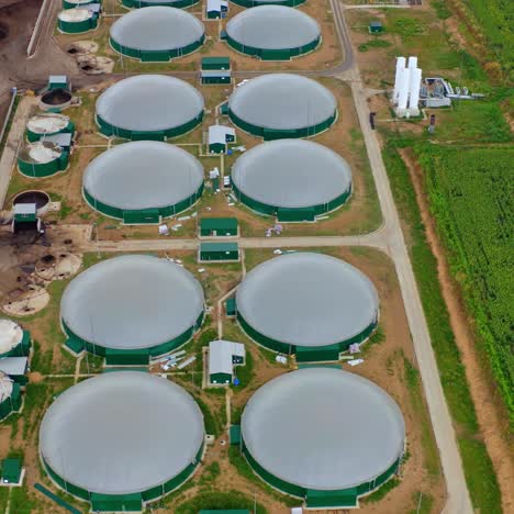 production of sustainable fuel called bio gas. new factory in field. video from above. ecological production.