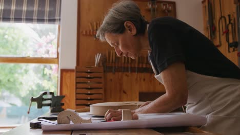 female luthier at work in her workshop