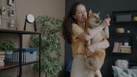 woman hugging shiba inu dog at home