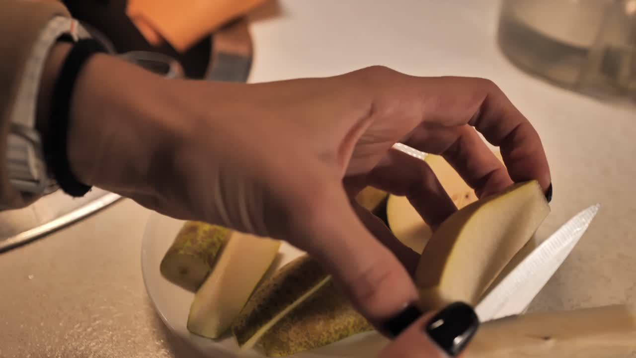 Slicing fresh pear into smaller pieces for a healthy snack, close-up - 4K.