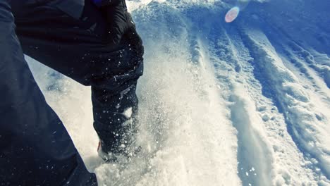 snowboarder sliding down through the snow