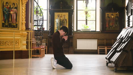 man praying indoors