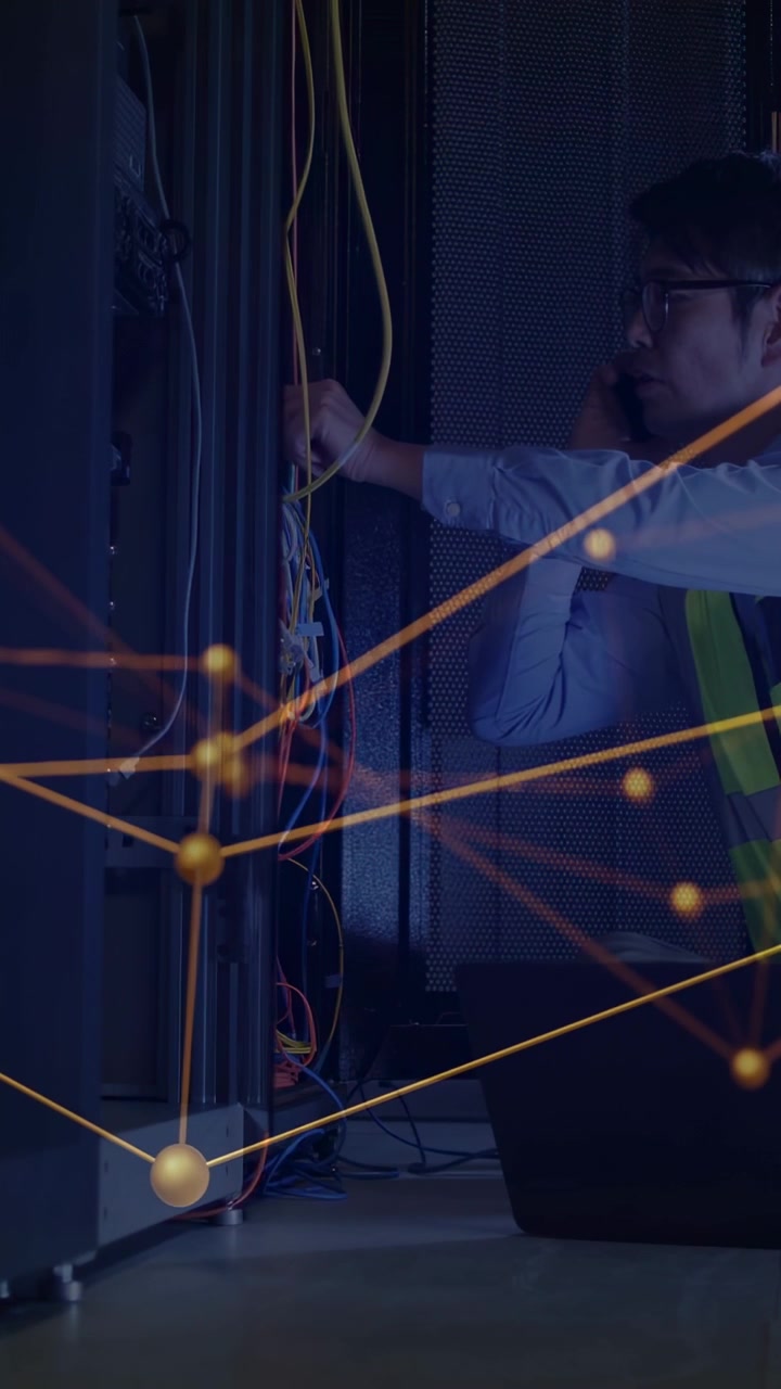 Vertical video: IT tech reaching rack, moving wires and phoning status, overlay over rack and tech