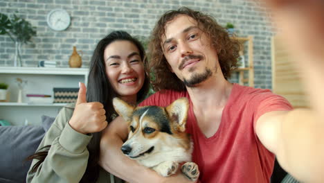 couple and dog selfie in living room
