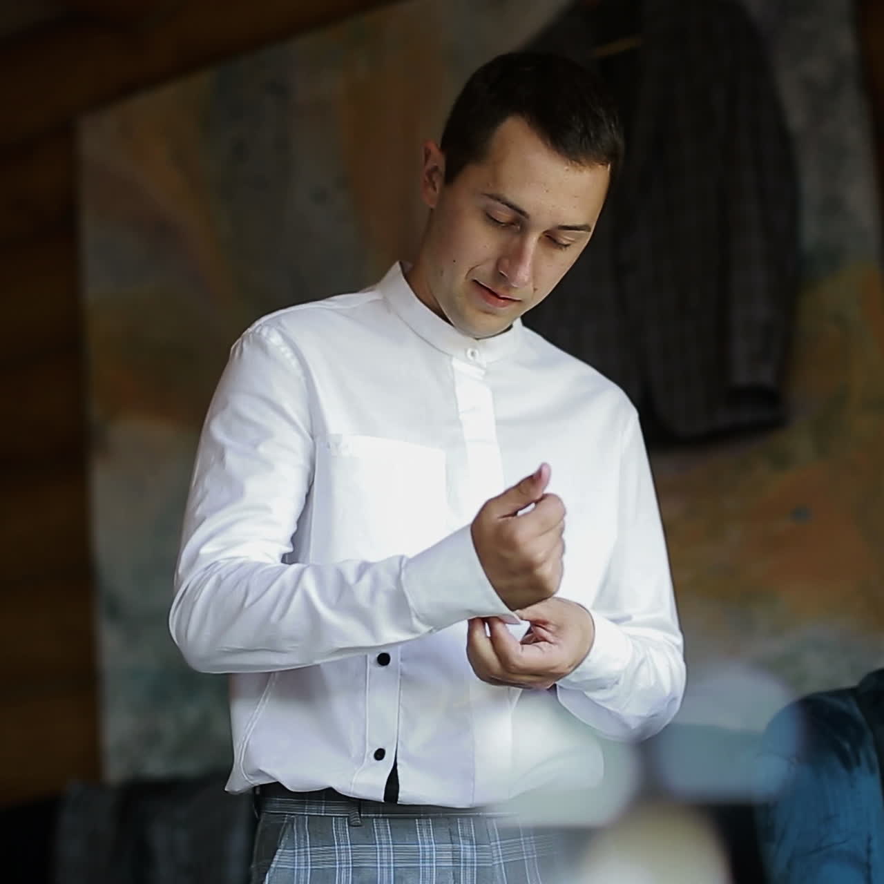 Morning of the groom. Handsome groom getting dressed and preparing for the wedding Square video