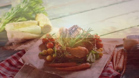 animation of landscape over turkey and vegetables on wooden background