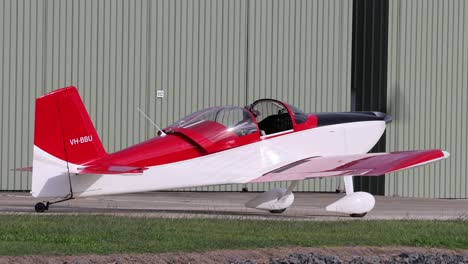 red and white plane moving on airport ground