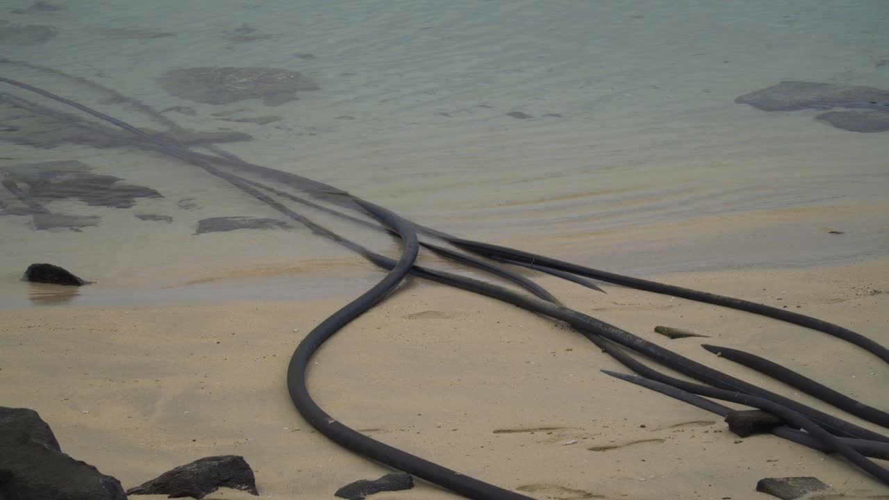 Desalination intake and outtake pipes going into warm water of an island in Fiji