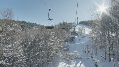 slow motion pov view riding ski lifts sunny winter snow day ski resort