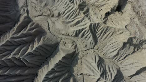 Aerial-Looking-Down-At-Weathered-Geological-Rock-Formations-With-Dry-River-Bed-At-Balochistan