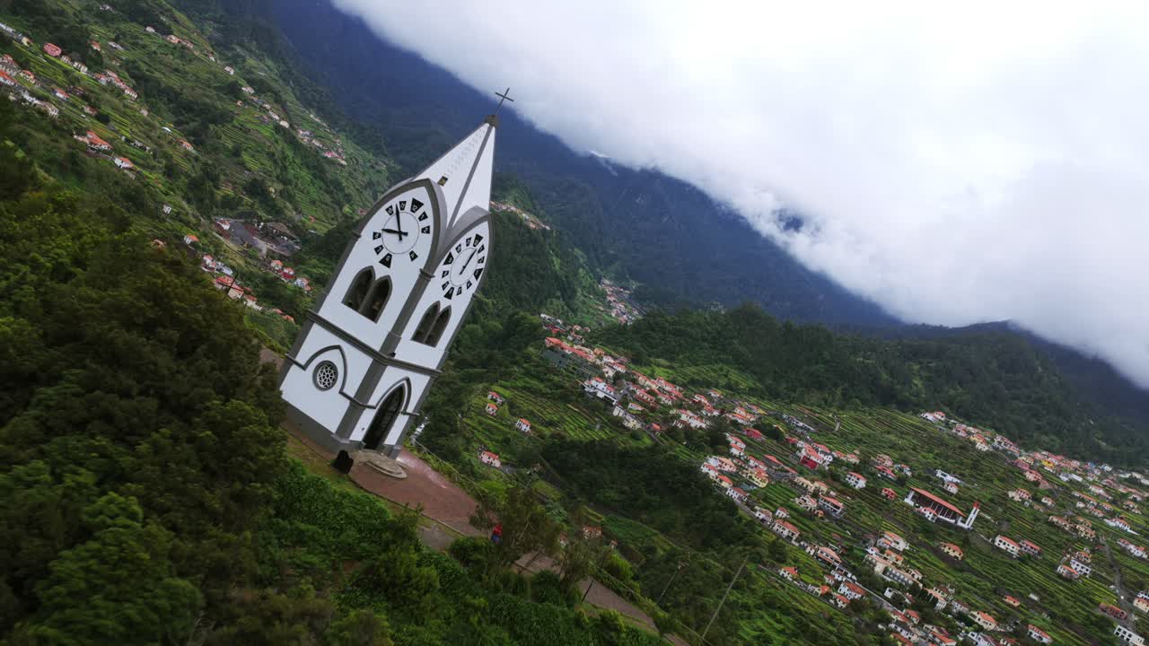 A picturesque chapel amidst lush greenery and mountain backdrop in Madeira