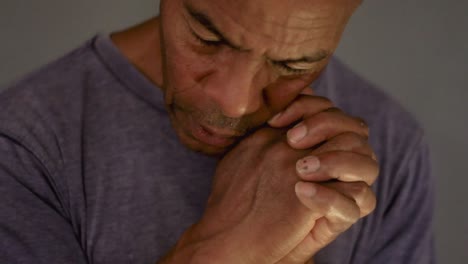 man praying to god with hands together on grey background stock video