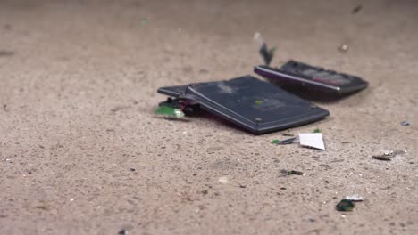 Hammer-smashing-calculator-and-breaking-into-pieces,-Slow-Motion-Closeup