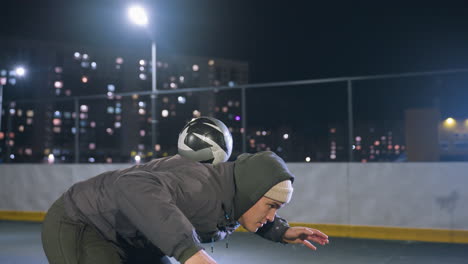 athlete skillfully throws ball, balances it on back, pushes it upward, and catches it with hands during nighttime practice on outdoor urban field surrounded by city lights and streetlights