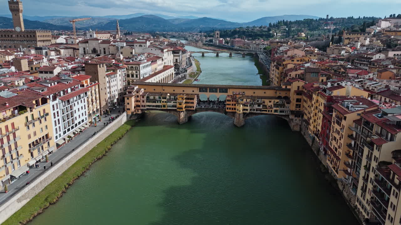 Bridge Ponte Vecchio in Florence, Italy, aerial view over Arno River with historic buildings