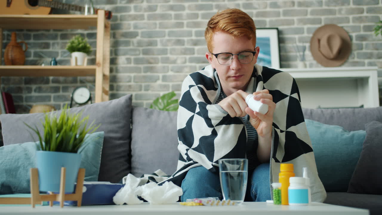 Sick Person Taking Medicine at Home