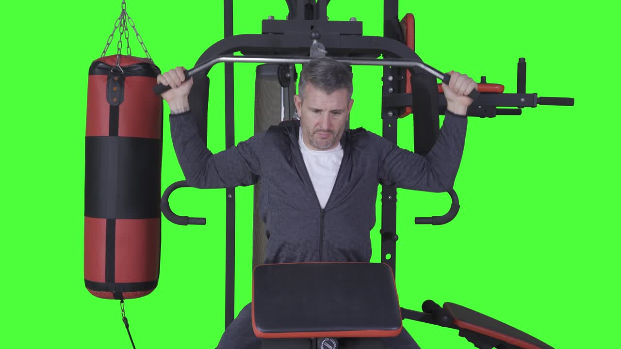 Handsome caucasian man exercising on gym machine
