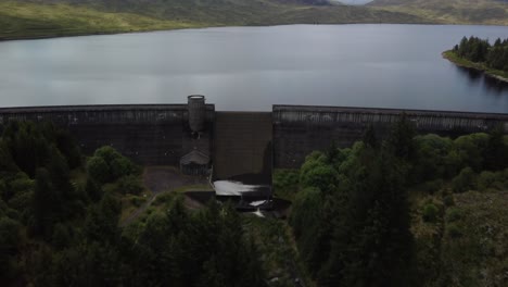 Drone-footage-above-a-large-reservoir-surround-by-mountains-and-fields