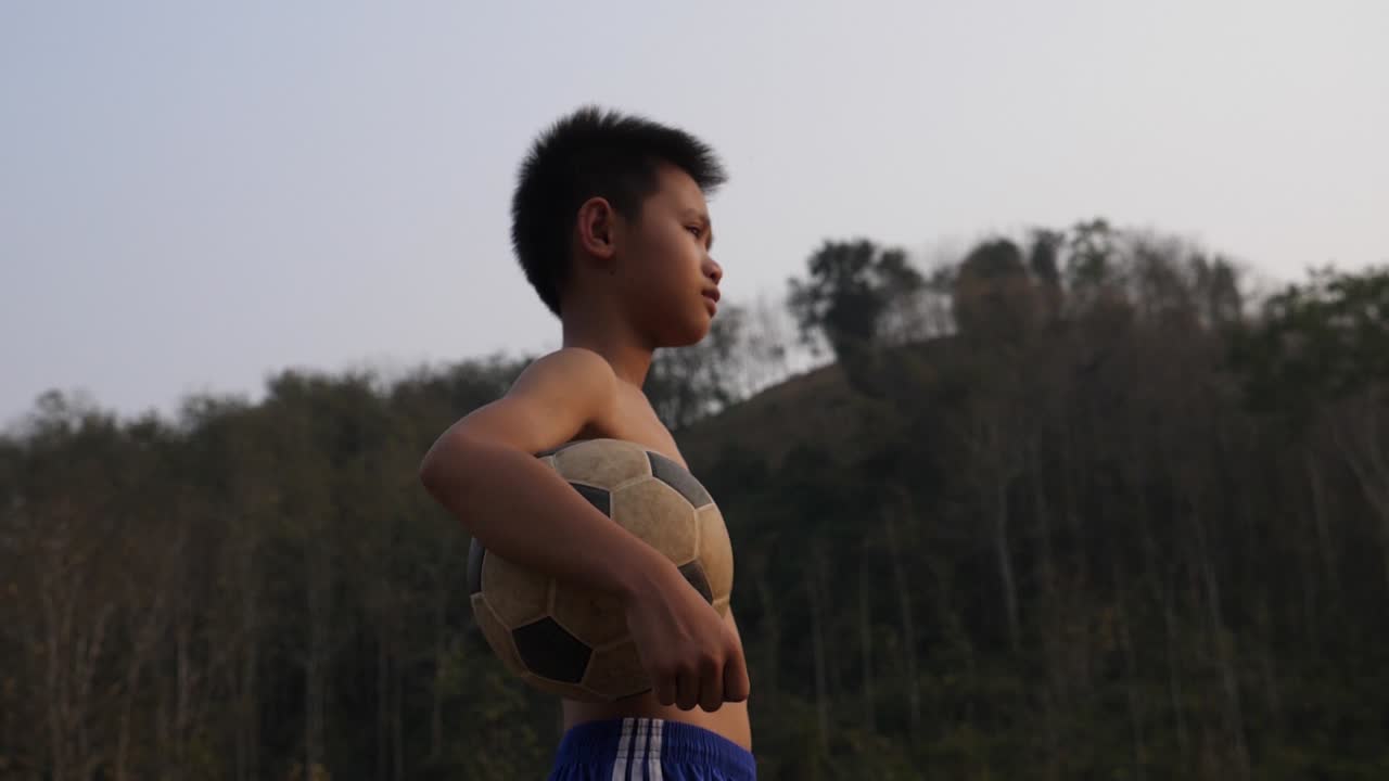 Boy Holding Soccer Ball Outdoors