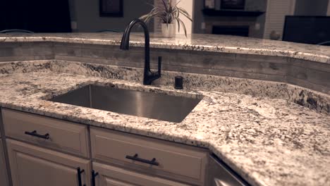 contemporary kitchen cabinet design with counter top made of granite stone, under mount sink and faucet