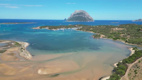 Sandy-Bay-and-Tavolara-Island-view-in-Porto-San-Paolo,-Sardinia,-Italy---Aerial-4k