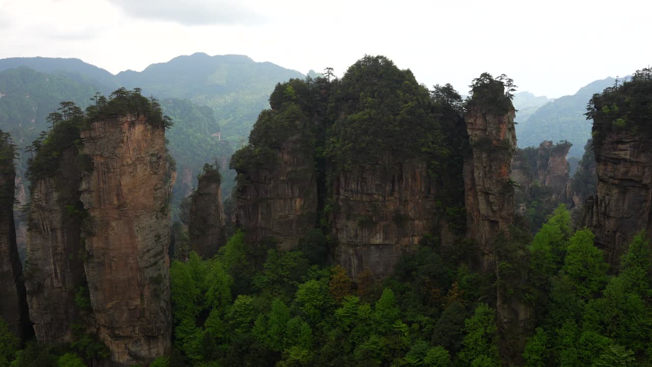 Panning right shot of Five Fingers Peak and other rock formations in Huangshi Village, Zhangjiajie, China