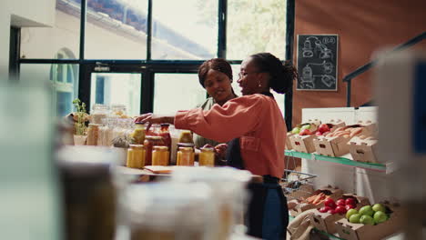 Retailer-showing-natural-homemade-sauces-in-reusable-jars