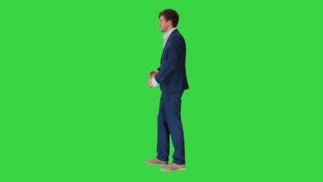 handsome young businessman standing arms crossed, smiling confidently on a green screen, chroma key