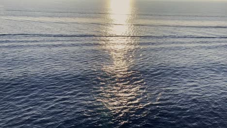 sunset reflections on the sea from a moving ship