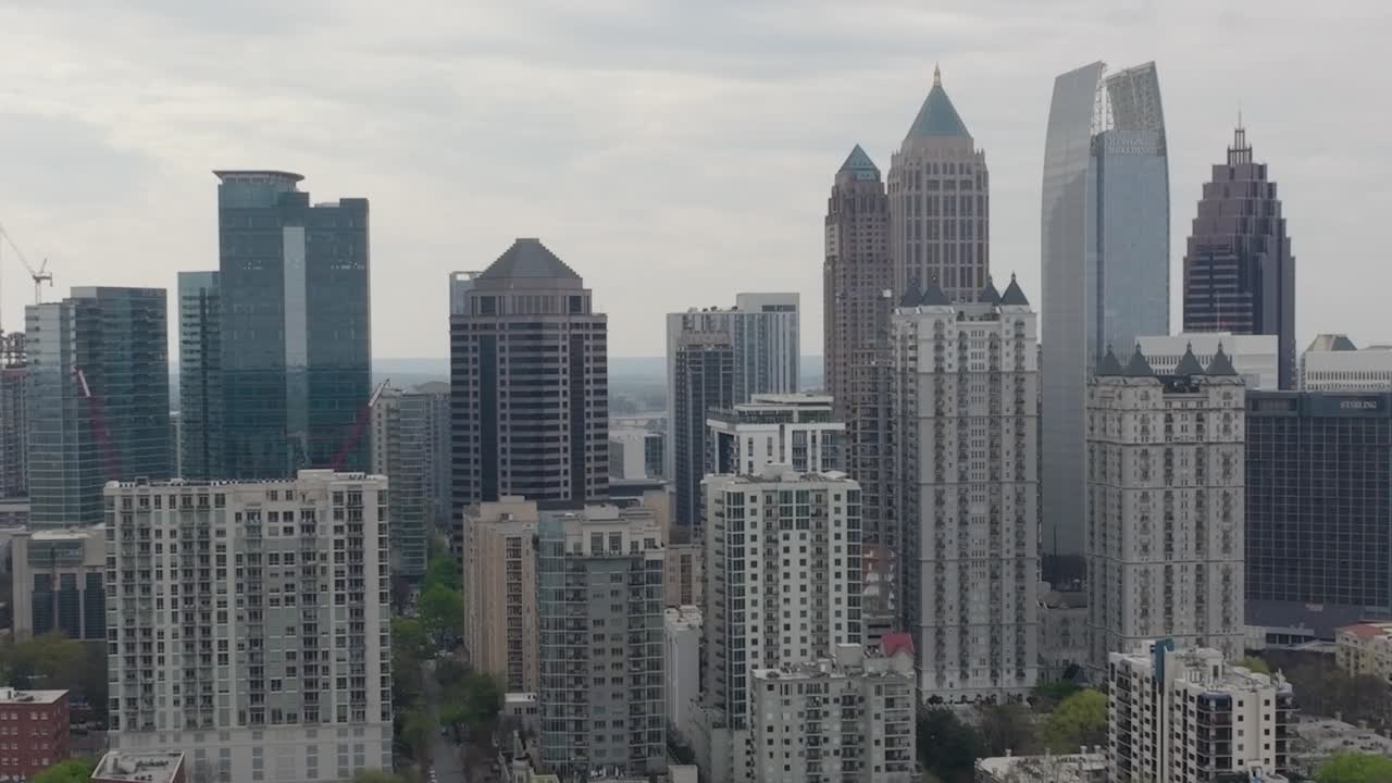 Close-up aerial pull-out view of downtown Atlanta cityscape skyline on a cloudy day featuring many of Atlanta's most iconic buildings