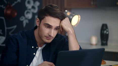 Businessman-getting-bad-news-on-laptop-at-home.-Sad-guy-looking-laptop-screen
