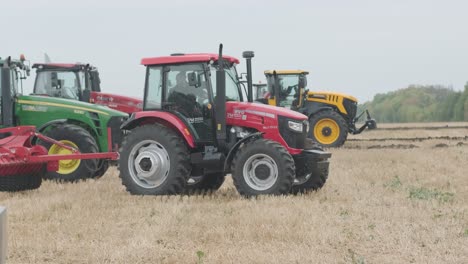 demonstration of agricultural machinery at an exhibition. tractors operate in the field, showcasing their capabilities and performance in action