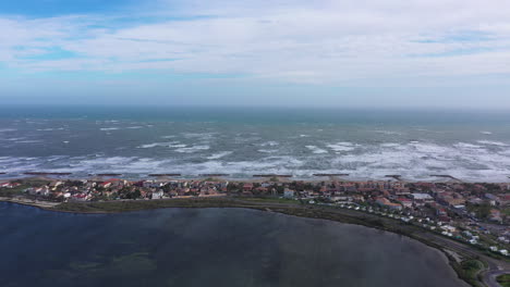 residential coastline city frontignan front beach aerial drone view.  windy day