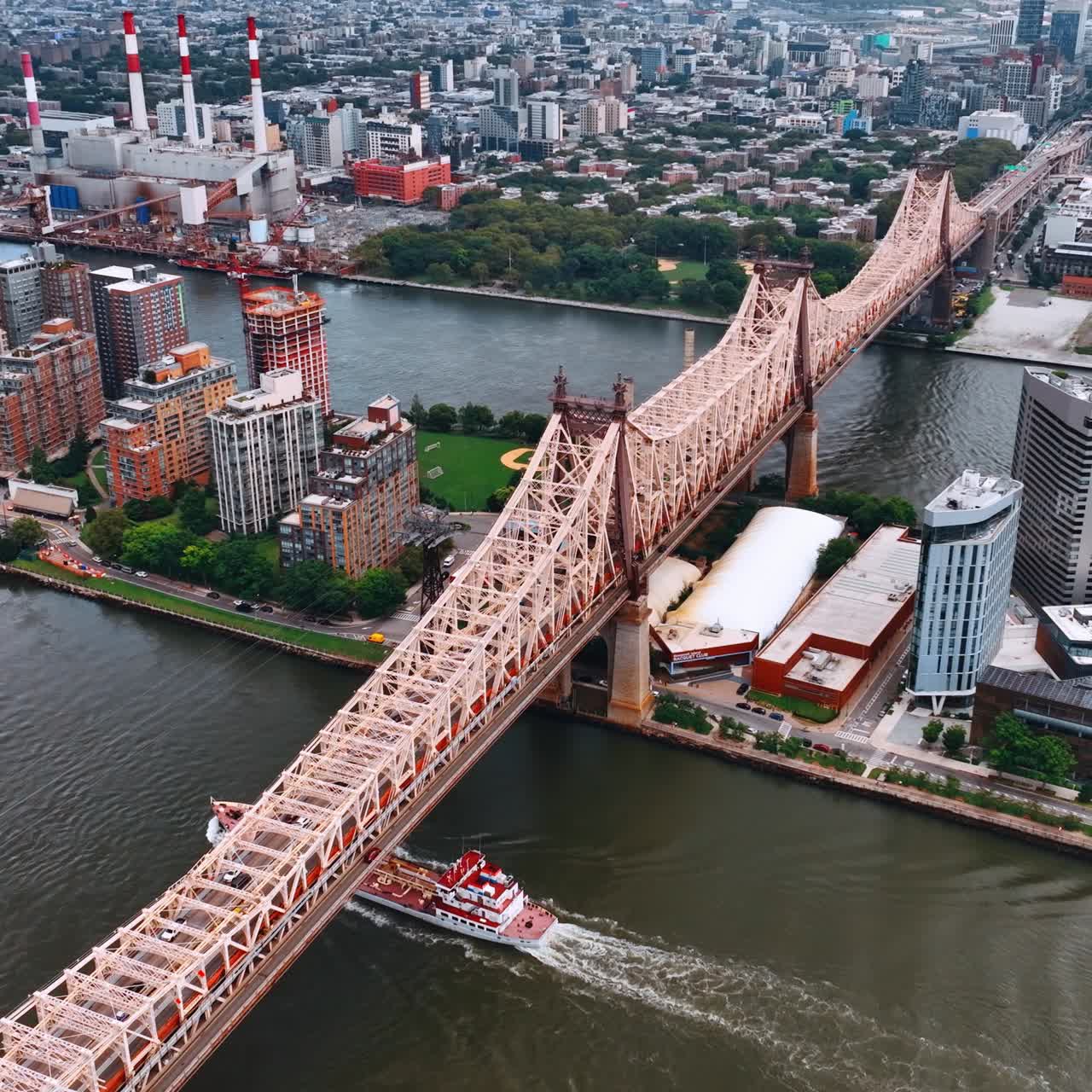 Majestic Queensboro Bridge view at daytime. Barge floating by the below the bridge. Top view