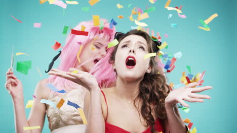 two women celebrating with confetti