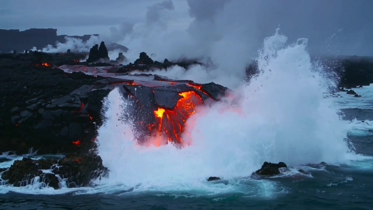 Colliding waves striking glowing lava waterfall from lava field at basalt shelf, producing steam