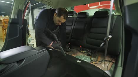 professional car cleaning. сar wash. interior detailing. dry clean and detail a car interior. deep seats cleaning. wiping foam in car wash. cleaning the car panel from dust. a vacuum cleaner