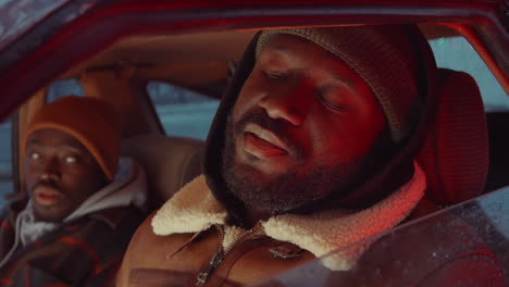 african american man talking with friend in car