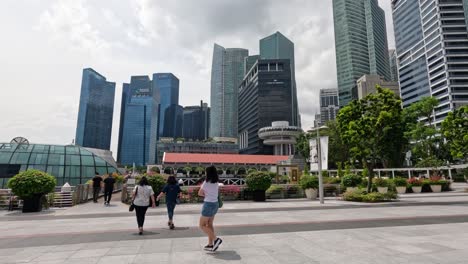 pedestrians walking through a bustling city plaza.