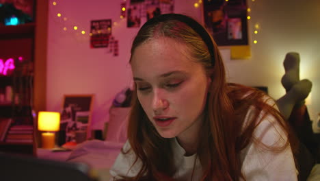 young woman using phone in bedroom