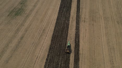 tractor plowing agricultural field