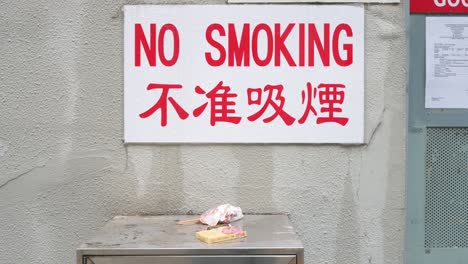 no smoking sign with cigarette litter