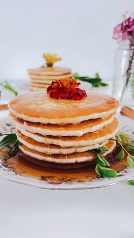stack of delicious honey-drizzled pancakes with flowers