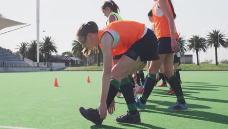 Jugadoras-De-Hockey-Haciendo-Ejercicio-En-El-Campo