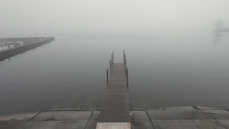 a dock on a misty lake